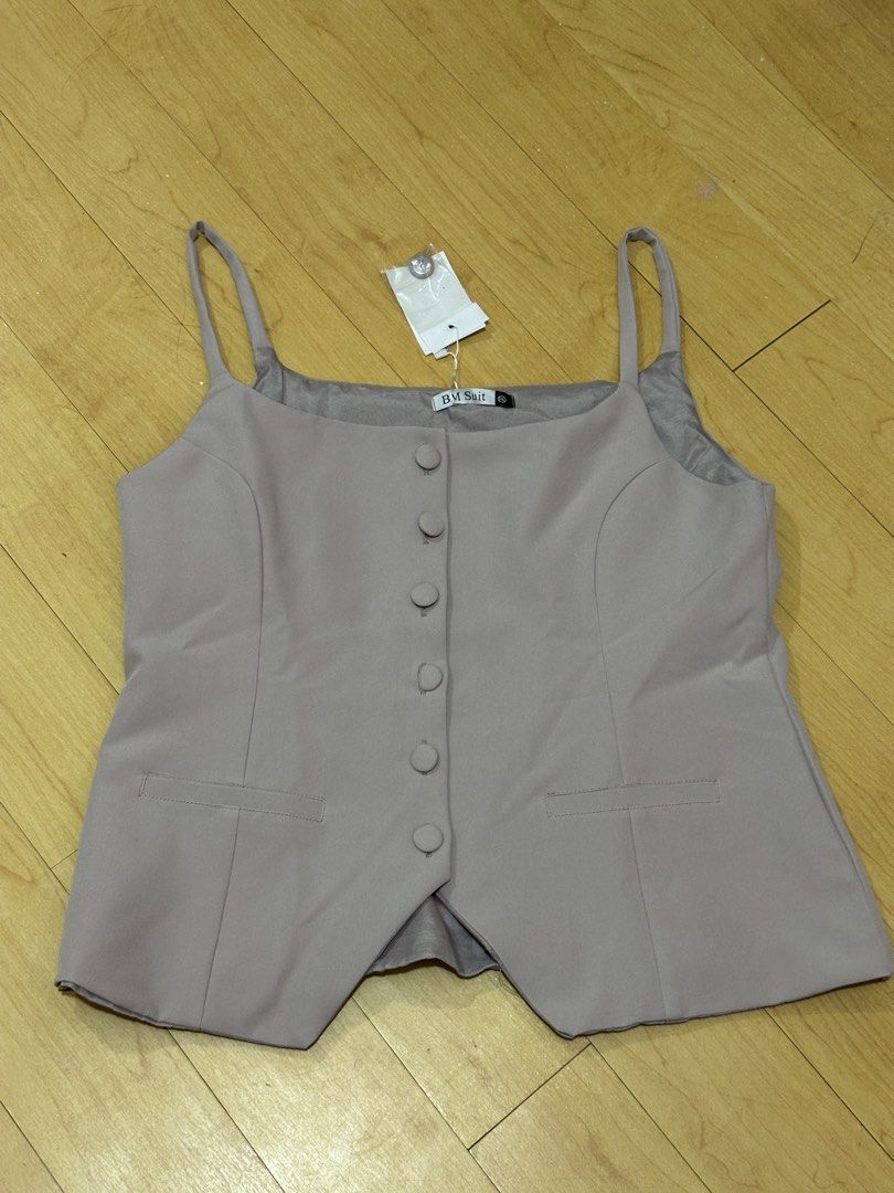 BM Suit Grey Vest Size XXL (Category: Vests) located in Manila. Submitted by chantalbe69523 (Listing ID 1467762425, Image 1). Description: - Brand: BM Suit - Size: XXL (fits true to size) - Color: Neutral taupe grey - Condition: Brand new, unworn with original tags attached - Features: Button-front closure with matching fabric buttons, square neckline, thin shoulder straps, faux pocket welts, and split curved hem - Inclusion: Extra button packet 