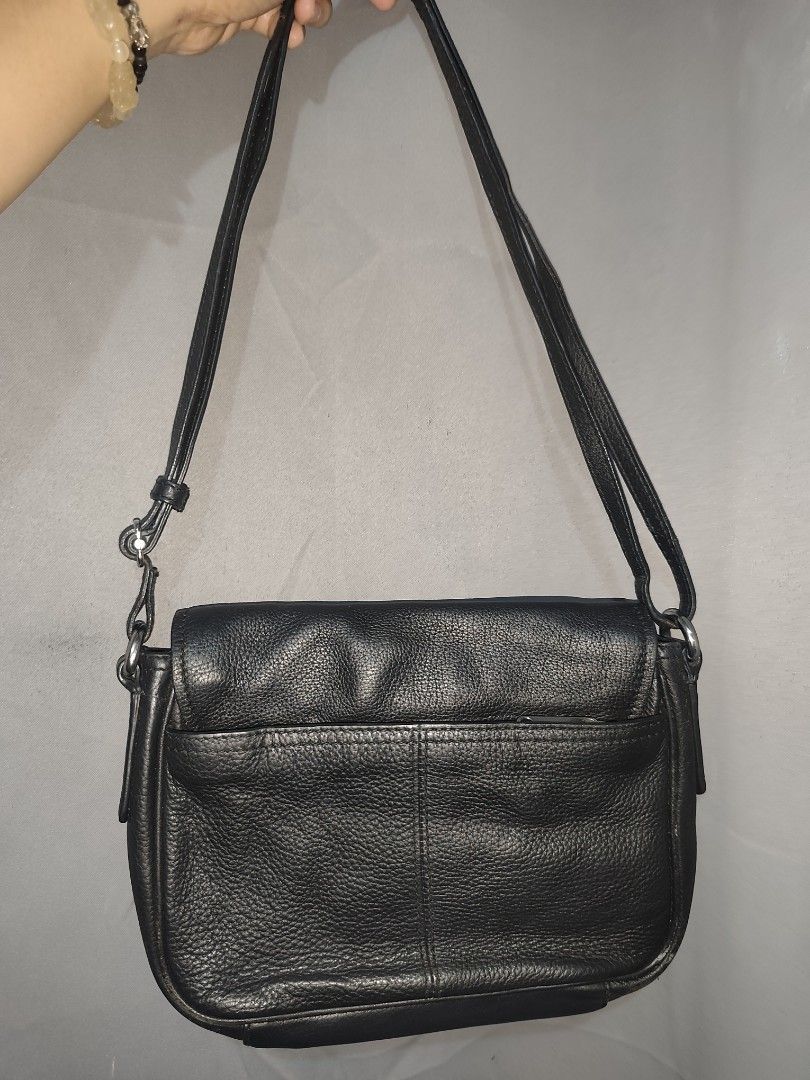 BREE Black leather crossbody (Category: Cross-body Bags) located in Rizal. Submitted by chicout (Listing ID 1467617804, Image 3). Description: - Color & Material: Black leather with textured grain - Closure: Flap front with a small round metal clasp - Strap: Adjustable shoulder strap with silver hardware - Storage: Back slip pocket for quick access and clean interior lining - Condition/Usage: Great everyday bag for carrying daily essentials. Usua
