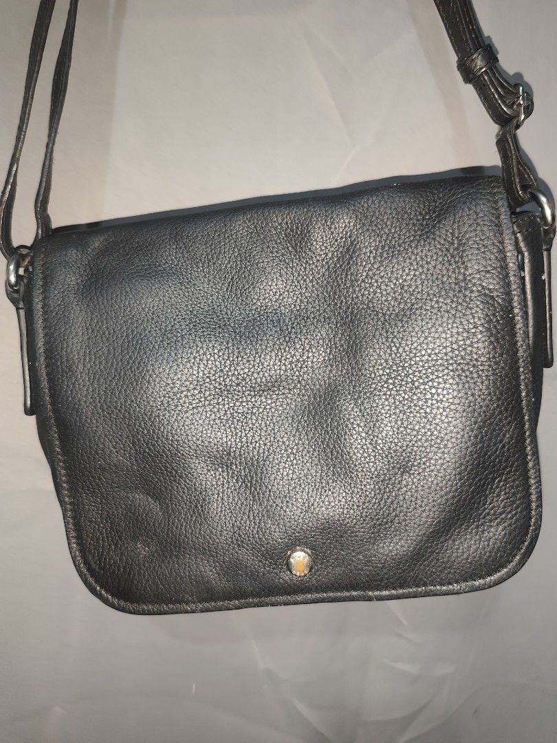 BREE Black leather crossbody (Category: Cross-body Bags) located in Rizal. Submitted by chicout (Listing ID 1467617804, Image 2). Description: - Color & Material: Black leather with textured grain - Closure: Flap front with a small round metal clasp - Strap: Adjustable shoulder strap with silver hardware - Storage: Back slip pocket for quick access and clean interior lining - Condition/Usage: Great everyday bag for carrying daily essentials. Usua