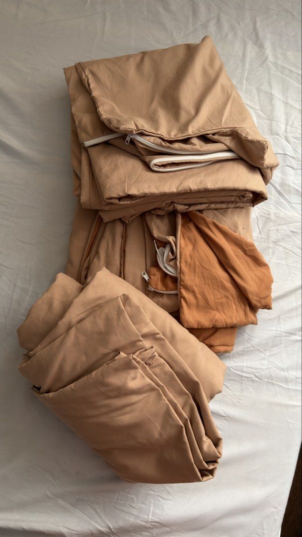 Brown Bedding Set with Zippers (Category: Bedding & Towels) located in Pasig City. Submitted by _missdee (Listing ID 1467671318, Image 1). Description: - Color: Warm camel and orange-brown tones - Set includes: 1 duvet cover and matching pillowcases - Material: Smooth, high-quality fabric - Closure: Convenient white zippers on the edges - Condition: Clean, freshly folded, and ready to use.