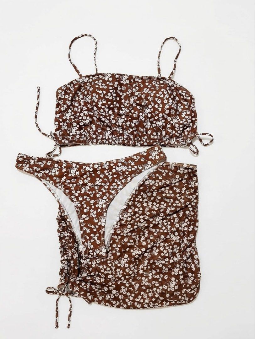 Brown Floral Bikini Set With Matching Sarong (Category: Bikinis & Swimsuits) located in Las Pinas. Submitted by dreas.thrift (Listing ID 1467767114, Image 1). Description: - Brand new, never worn - 3-piece set: tube top, matching bottoms, and side-tie sarong skirt - Trendy brown and white floral print - Stretchy and comfortable fabric - Adjustable strings on the top and skirt for a custom fit - Ideal for beach trips and pool days.