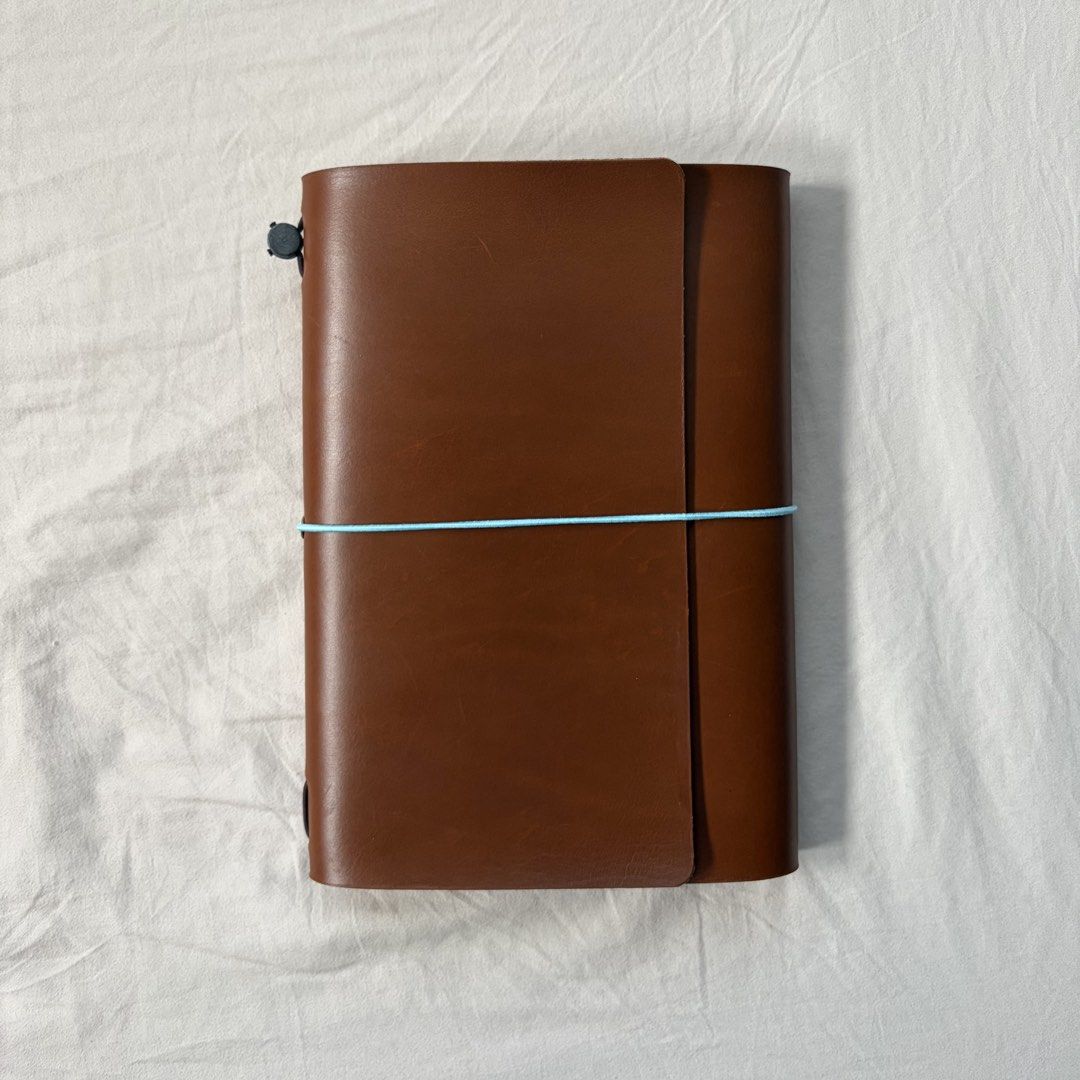 A5 genuine leather trifold journal cover (Category: Stationery & School Supplies) located in Quezon City. Submitted by minorchair (Listing ID 1467650721, Image 1). Description: - brand new, never used A5 genuine leather leather trifold journal cover in tan brown - with a light blue elastic cord - Filled with 2 free inserts - Versatile use: ideal for journaling, sketching, or daily planning.