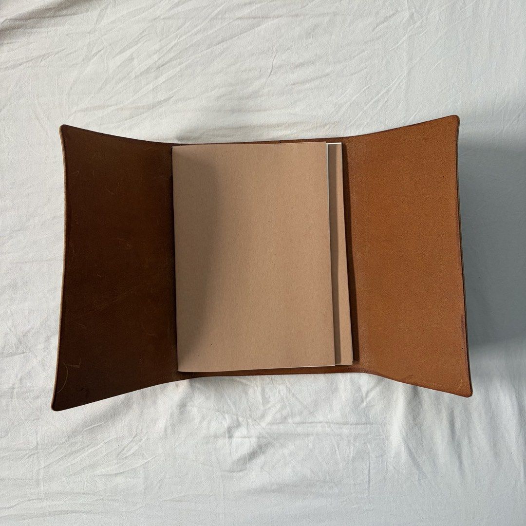 A5 genuine leather trifold journal cover (Category: Stationery & School Supplies) located in Quezon City. Submitted by minorchair (Listing ID 1467650721, Image 2). Description: - brand new, never used A5 genuine leather leather trifold journal cover in tan brown - with a light blue elastic cord - Filled with 2 free inserts - Versatile use: ideal for journaling, sketching, or daily planning.