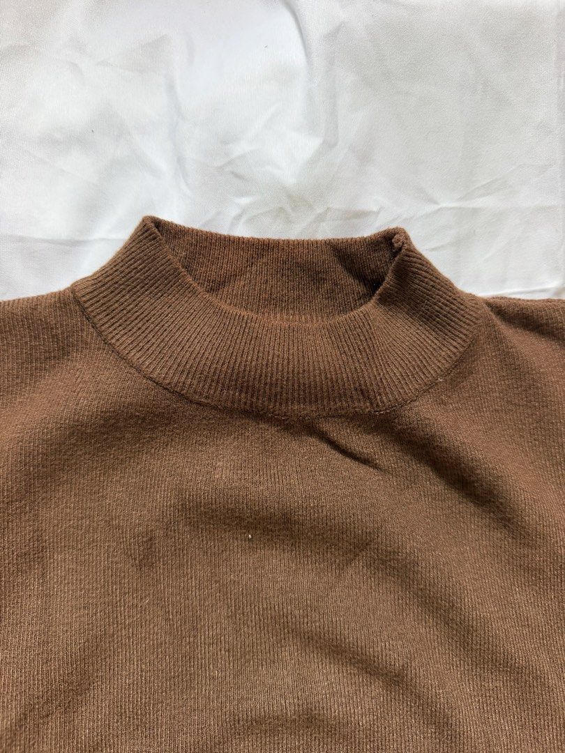 Brown Mock Neck Short Sleeve Knit Top (Category: Blouses) located in Las Pinas. Submitted by ann.co. (Listing ID 1467745336, Image 2). Description: - Color: Brown - Material: Soft knitted fabric - Design: Mock neck with ribbed collar, cuffs, and hem - Fit: Relaxed fit through the body - Versatility: Great neutral piece for layering or standalone wear.