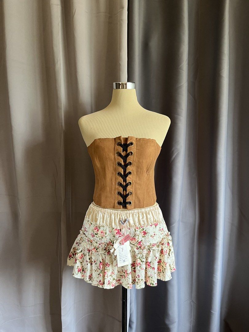 Brown Suede Front Lace Up Corset Top (Category: Sleeveless) located in Cagayan de Oro. Submitted by curated_closetph (Listing ID 1467767912, Image 1). Description: — Size : XS - S — Color: Brown / Tan — Soft faux suede with a western-inspired look — Front lace-up detail with black ribbon and metal grommets — Strapless tube silhouette — Structured boning for waist shaping — Straight hemline for versatile styling — Exposed metallic back zipper clos
