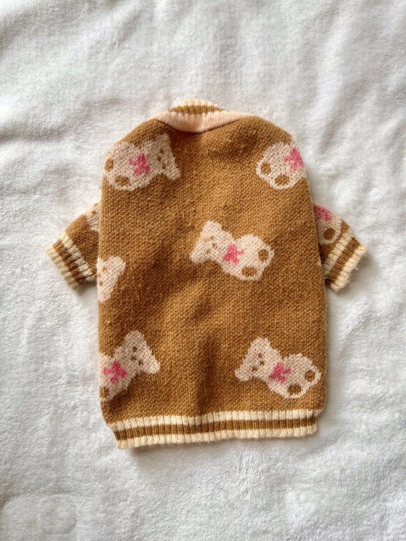 Brown Teddy Bear Pattern Knit Pet Cardigan (Category: Coats, Jackets and Outerwear) located in Taguig. Submitted by call.me.eni (Listing ID 1467318052, Image 2). Description: - Adorable brown knit cardigan for pets with all-over teddy bear pattern and pink bows - Classic V-neck design featuring 3 black front buttons for easy wear - Cream striped ribbing at the collar, cuffs, and hem for a snug fit - Soft pink inner lining for extra comfort and wa