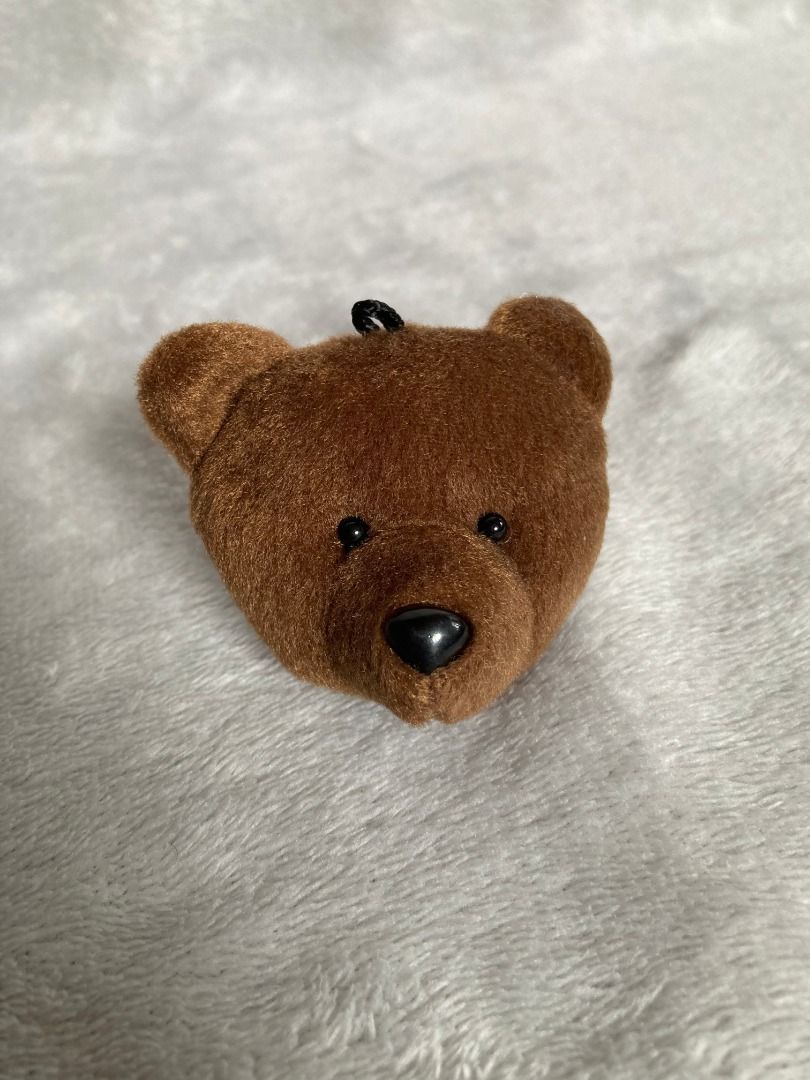 Brown Teddy Bear Phone Grip Holder Stand (Category: Mounts & Holders) located in Rizal. Submitted by sheeraay (Listing ID 1467707020, Image 1). Description: - Adorable fuzzy brown teddy bear design made with soft plush material - Features secure plastic nose and bead eyes for a cute look - Strong 3M adhesive backing for easy and reliable attachment to phone cases - Improves phone handling for easier one-handed use - Functions as a handy hands-fre