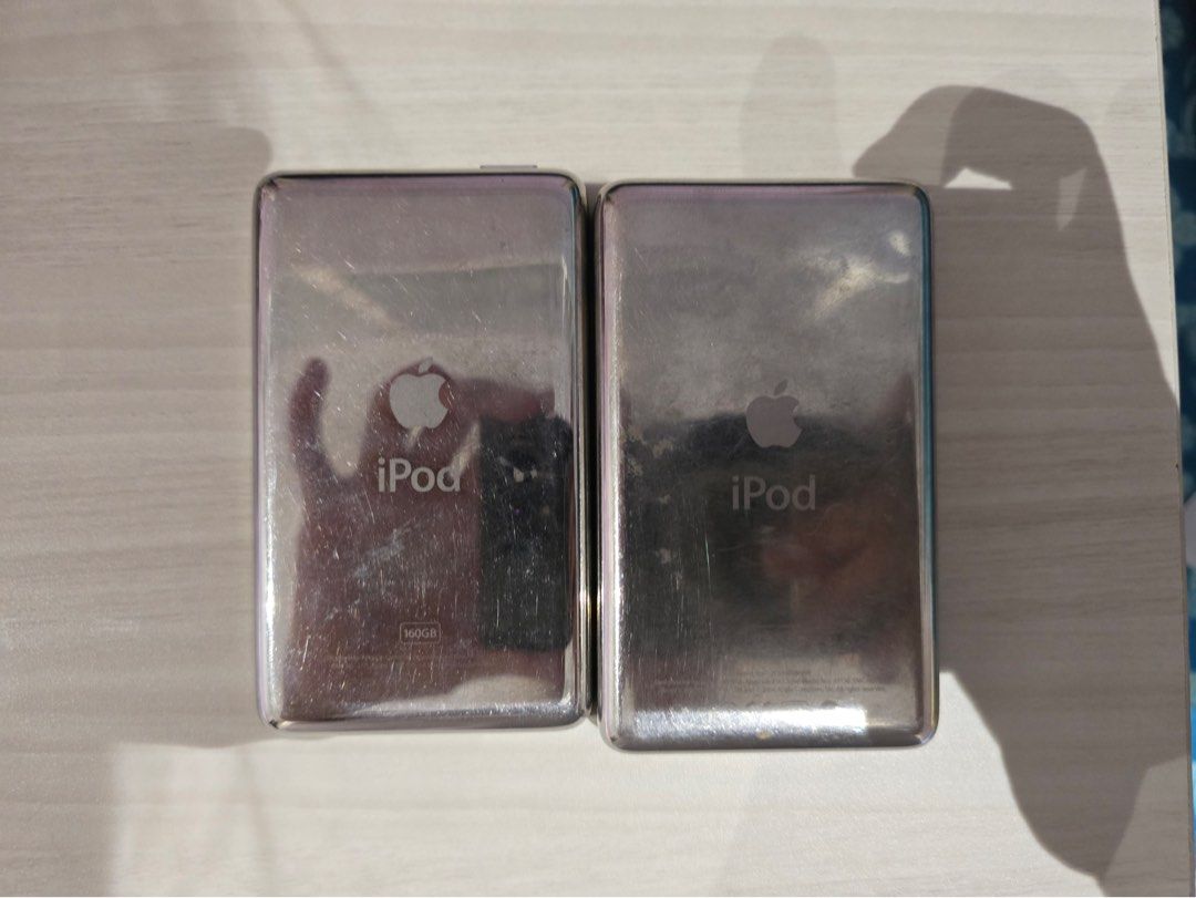 BUNDLE Apple iPod Classic Silver and Black (Category: Portable Music Players) located in Manila. Submitted by milleshoppppp (Listing ID 1467772895, Image 2). Description: Vintage Apple iPod Bundle (For Parts / Repair / Flash-Modding Project) • iPod Classic (7th gen) (Silver) • iPod 5th Gen “Video” (Black) • Cosmetics: Tactile click wheels, intact screens, and standard vintage surface scratches. Price: ₱1,800 for both (still negotiable).