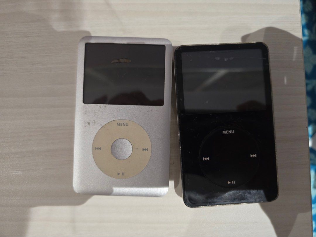 BUNDLE Apple iPod Classic Silver and Black (Category: Portable Music Players) located in Manila. Submitted by milleshoppppp (Listing ID 1467772895, Image 1). Description: Vintage Apple iPod Bundle (For Parts / Repair / Flash-Modding Project) • iPod Classic (7th gen) (Silver) • iPod 5th Gen “Video” (Black) • Cosmetics: Tactile click wheels, intact screens, and standard vintage surface scratches. Price: ₱1,800 for both (still negotiable).
