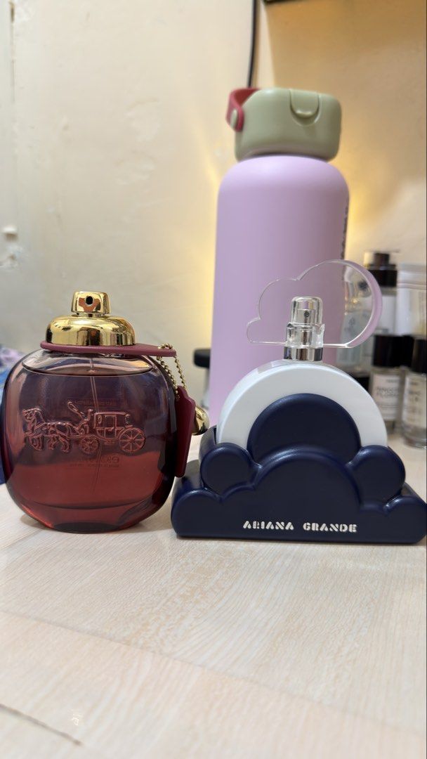 Bundle!! Coach Wild Rose & Ariana Grande Cloud intense Perfume (Category: Fragrance & Deodorants) located in Muntinlupa City. Submitted by ynna1207 (Listing ID 1467737087, Image 1). Description: - Coach Wild Rose EDP: Iconic round red bottle with horse/carriage engraving and leather tag - Ariana Grande Cloud EDP: Distinct dark blue cloud base with white top - Condition: Both bottles are mostly full - Perfect addition to any fragrance collection -