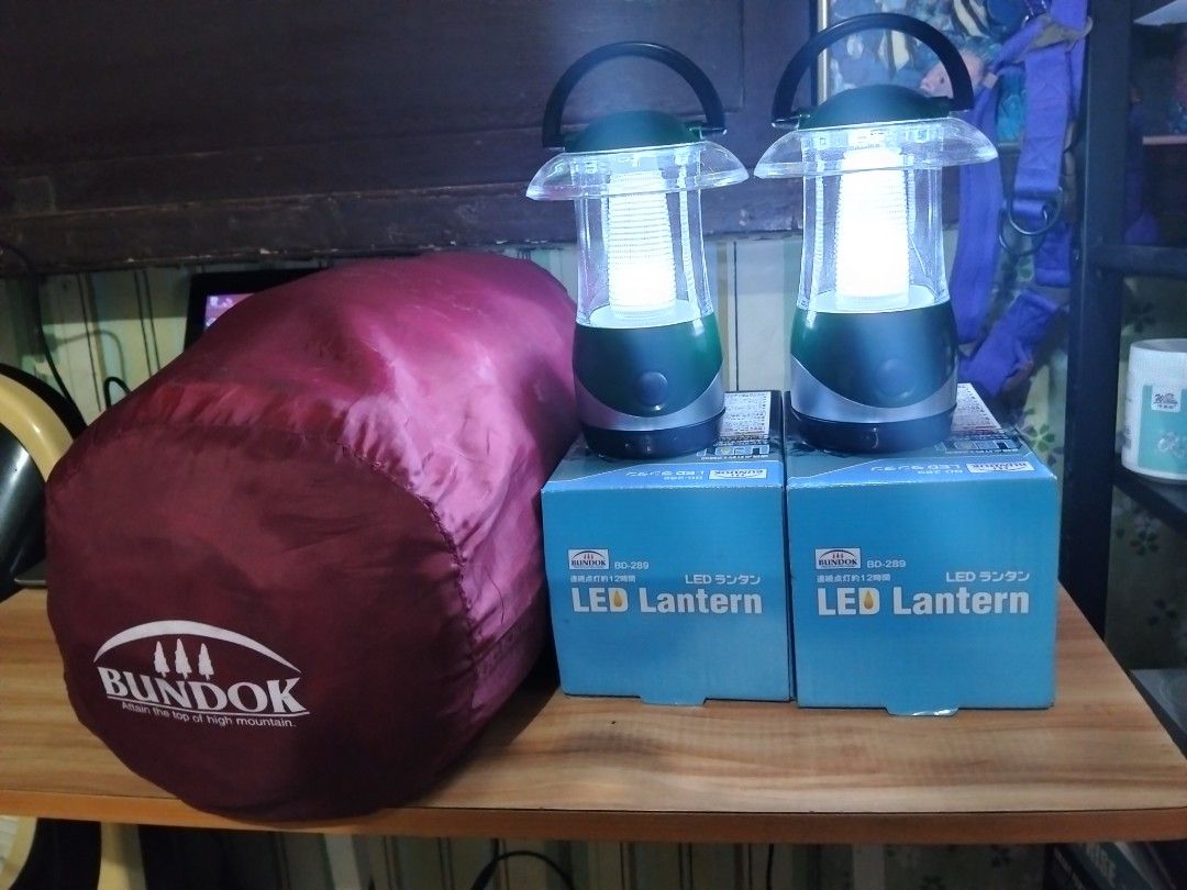 Bundok BD-289 LED Lanterns and Sleeping Bag Set (Category: Hiking & Camping) located in Abucay. Submitted by cristineca20489 (Listing ID 1467803065, Image 2). Description: - Bundle includes: 2x Bundok BD-289 LED lanterns (green) and 1x dark red Bundok sleeping bag - Condition: Both lanterns tested and working, emit bright white light (3 small batteries can last 12 hours.) - Packaging: Lanterns come with their original blue boxes - Sleeping Bag: F