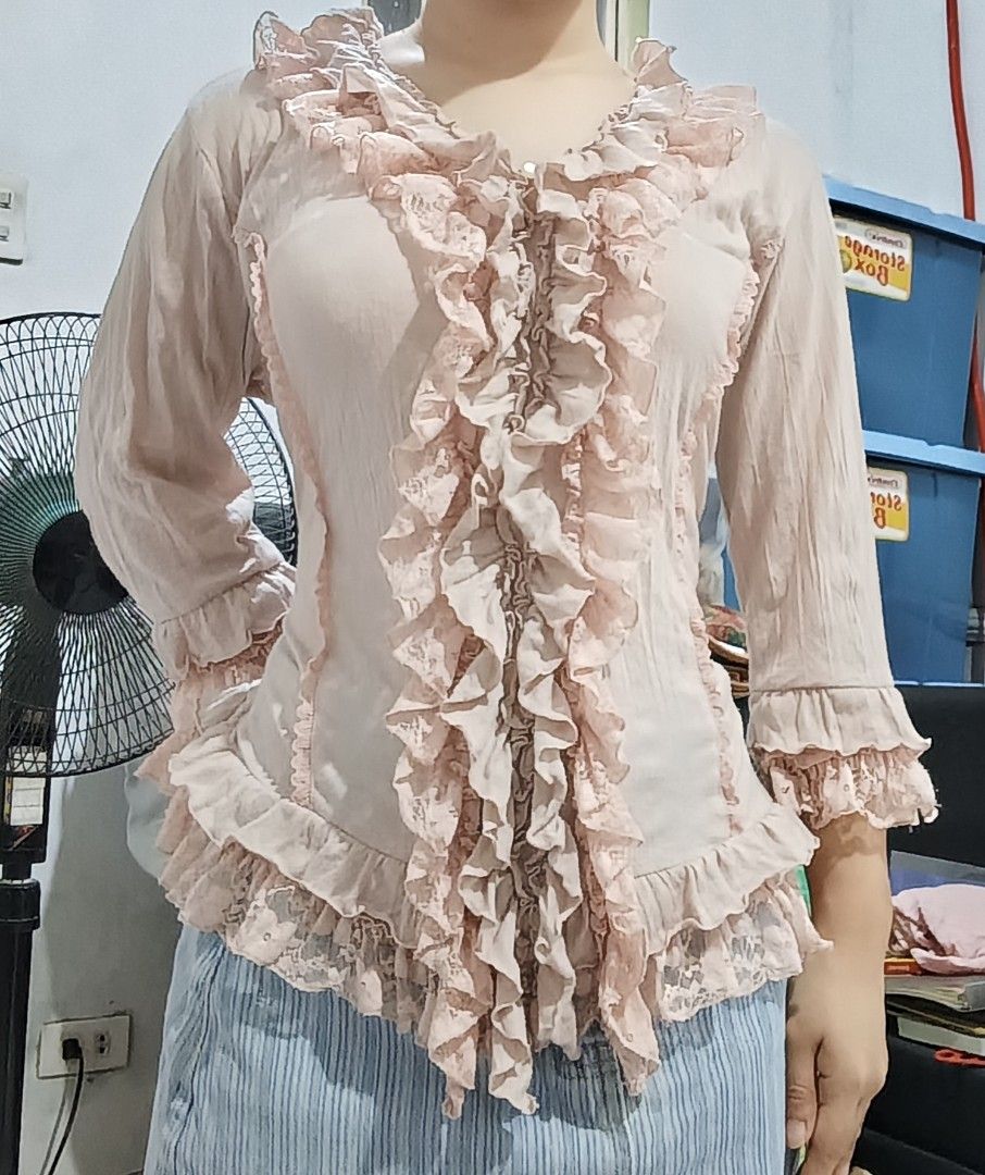 C. Rosiere Ruffled Lace Blouse (Category: Blouses) located in Manila. Submitted by dear__riri__ (Listing ID 1463558303, Image 3). Description: - Brand: C. Rosiere - Color: Light pinkish-beige - Style: Feminine, vintage-inspired - Details: Ruffles and lace trim on neckline and front placket - Closure: Button-up front with a single pearl button at the top - Sleeves: Long sleeves.