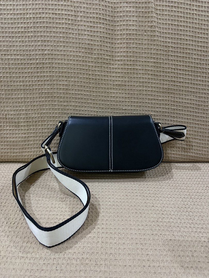 Call It Spring Black Flap Saddle / Crossbody Bag w/ Webbing Strap (Category: Luxury Bags & Wallets) located in Paranaque City. Submitted by honeykkkk (Listing ID 1467715641, Image 1). Description: Brand: Call It Spring (ALDO Group) Style: Flap Saddle Crossbody Bag / Shoulder Bag Color: Black with White Contrast Stitching & Two-Tone Webbing Strap Material: Smooth Vegan Leather (100% Synthetic) Condition: Brand New, Never Used / Never Touched (100%