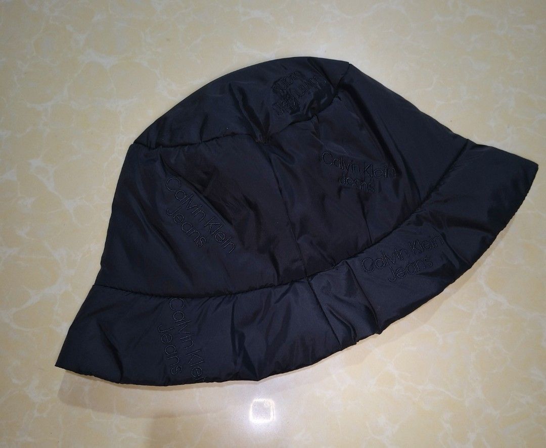 Calvin Klein Jeans Black Bucket Hat (Category: Caps & Hats) located in Manila. Submitted by purefire-477a (Listing ID 1467720942, Image 3). Description: - Brand: Calvin Klein Jeans - Color: Classic Black - Size: Adult One Size (Fits Most) - Material: Lightweight nylon (foldable and packable) - Design: All-over subtle embroidered logo print - Condition: Brand new with tags attached, clean inside and out.