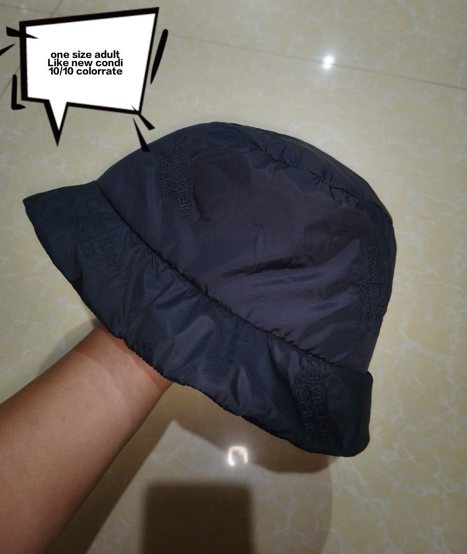 Calvin Klein Jeans Black Bucket Hat (Category: Caps & Hats) located in Manila. Submitted by purefire-477a (Listing ID 1467720942, Image 1). Description: - Brand: Calvin Klein Jeans - Color: Classic Black - Size: Adult One Size (Fits Most) - Material: Lightweight nylon (foldable and packable) - Design: All-over subtle embroidered logo print - Condition: Brand new with tags attached, clean inside and out.