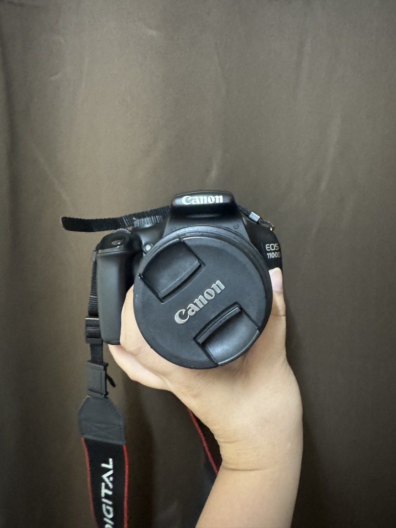 Canon EOS 1100D DSLR Camera with Strap (Category: Cameras) located in Manila. Submitted by khimellorin (Listing ID 1467728624, Image 1). Description: - Model: Canon EOS 1100D DSLR Camera Body - Lens: Zoom lens included with front lens cap - Accessories: Original Canon neck strap - Condition: Tested and 100% working - Color: Classic black finish - Perfect for beginners and photography projects - with bag and charger.