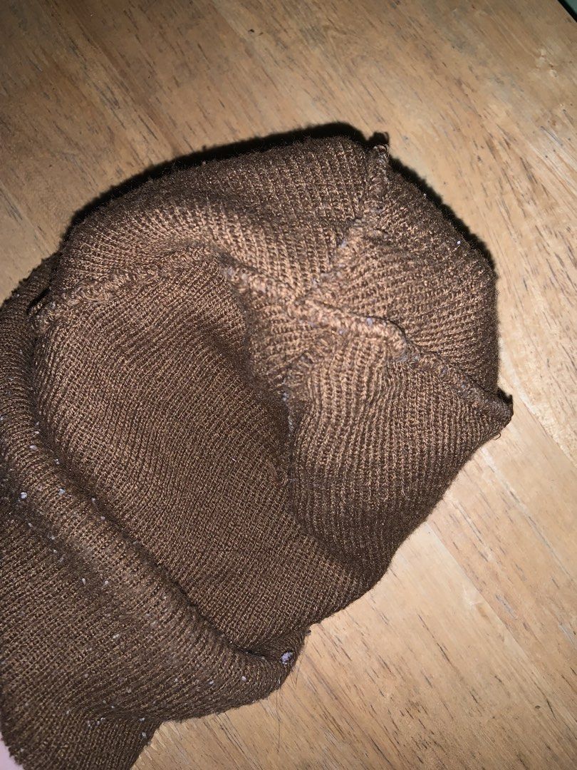 Carhartt Brown Knit Beanie Hat (Category: Caps & Hats) located in Manila. Submitted by pick_by_g (Listing ID 1467764324, Image 3). Description: - Color: Classic Brown - Material: Stretchy rib-knit fabric for a comfortable fit - Design: Fold-up cuff with signature Carhartt logo patch on the front - Style: Warm winter essential and daily casual streetwear accessory - Condition: Normal wear with some minor lint on the fabric.