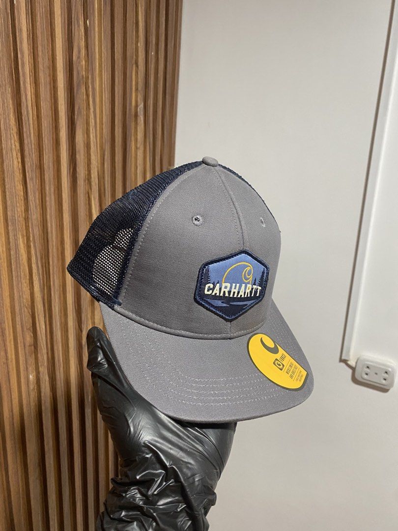Carhuartt Canvas Mesh-Back Quality Patch Cap AH5364-M Grey (Category: Caps & Hats) located in Caloocan City. Submitted by heatedcaps4425 (Listing ID 1467803659, Image 2). Description: - Brand: Carhartt - Condition: Brand new with original tags and brim sticker - Color: Grey with blue mountain/river graphic patch logo - Material: 100% cotton shell, 100% polyester mesh - Fit: Fully adjustable snapback closure - Origin: Made in Bangladesh.