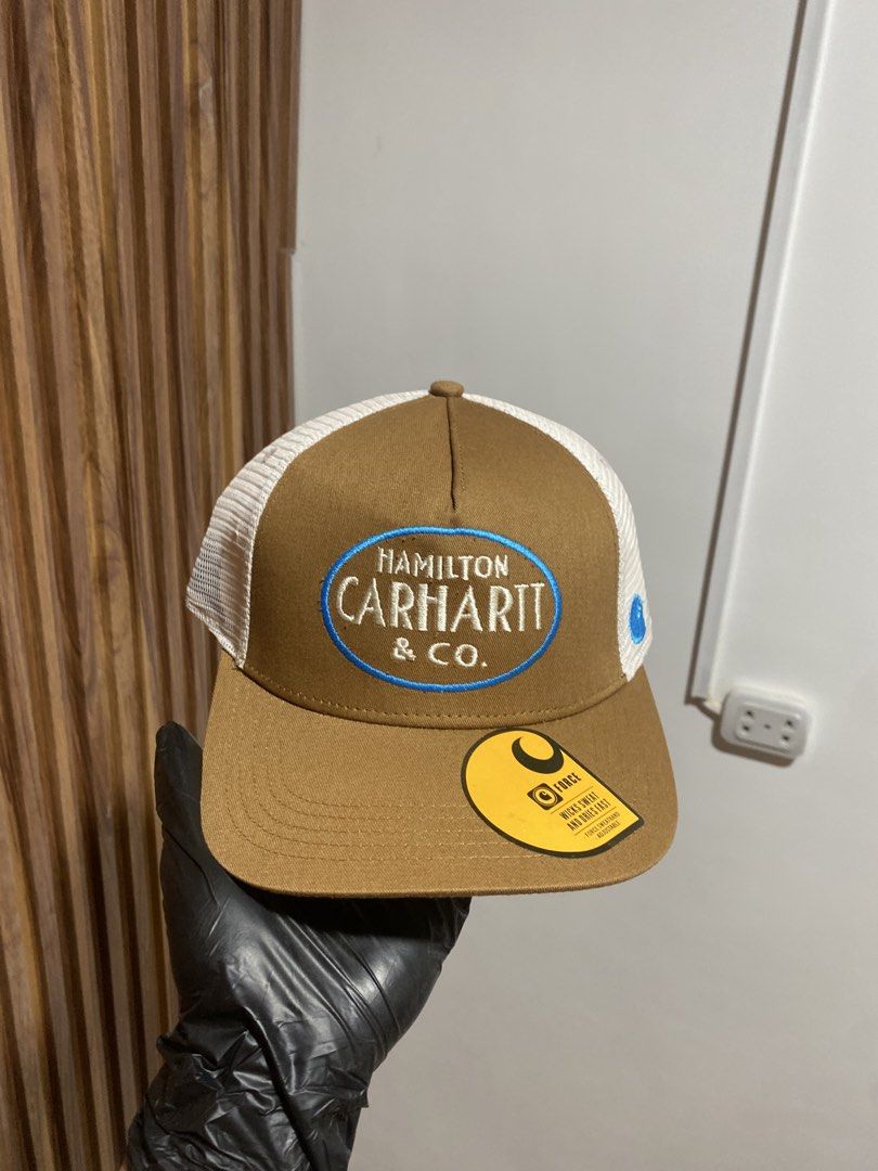 Carinth Hamilton & Co. Trucker Hat Brown White (Category: Caps & Hats) located in Caloocan City. Submitted by heatedcaps4425 (Listing ID 1467803813, Image 1). Description: - Brand: Carhartt Force - Condition: Brand new with original tags, never worn - Color: Brown with white mesh back - Fit: Adjustable snapback closure, fits most sizes - Details: Features Hamilton Carhartt & Co embroidered patch on the front - Ideal for: Everyday casual wear and 