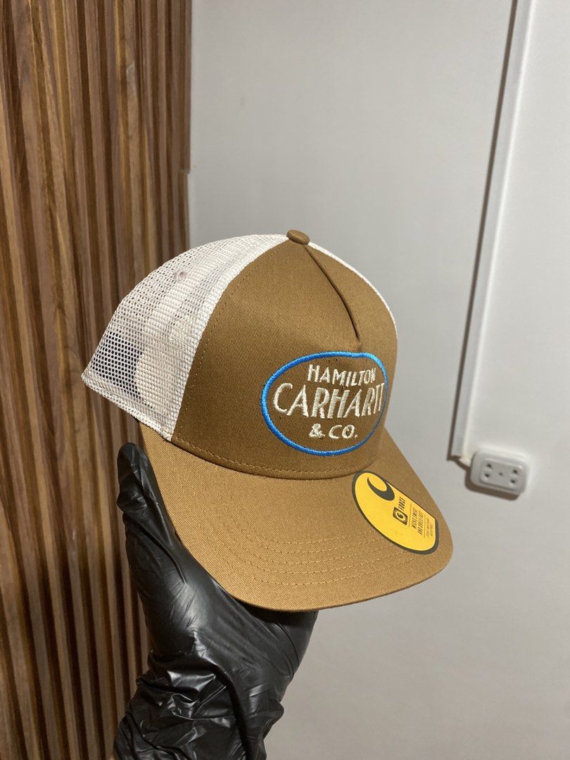 Carinth Hamilton & Co. Trucker Hat Brown White (Category: Caps & Hats) located in Caloocan City. Submitted by heatedcaps4425 (Listing ID 1467803813, Image 2). Description: - Brand: Carhartt Force - Condition: Brand new with original tags, never worn - Color: Brown with white mesh back - Fit: Adjustable snapback closure, fits most sizes - Details: Features Hamilton Carhartt & Co embroidered patch on the front - Ideal for: Everyday casual wear and 