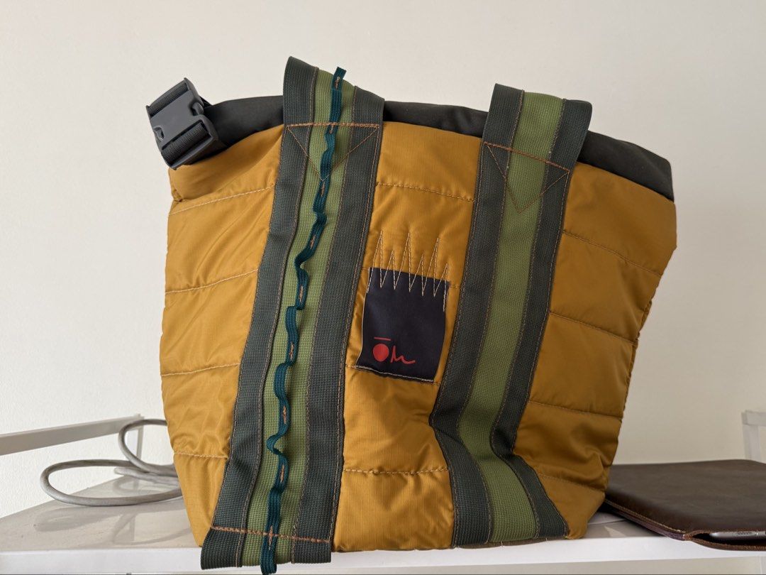 Carry Om Garuda 13” (Category: Tote Bags) located in Binan City. Submitted by julia1923 (Listing ID 1467636354, Image 1). Description: - RFS not a fan of the brand anymore - Fits a Macbook air - Color Block Design: Stylish mustard yellow, green, and dark grey with unique wavy blue stitching - Spacious & Organized: Large main compartment with a secure zipper closure and multiple interior pockets/pouches - Durable Material: High-quality quilted nyl