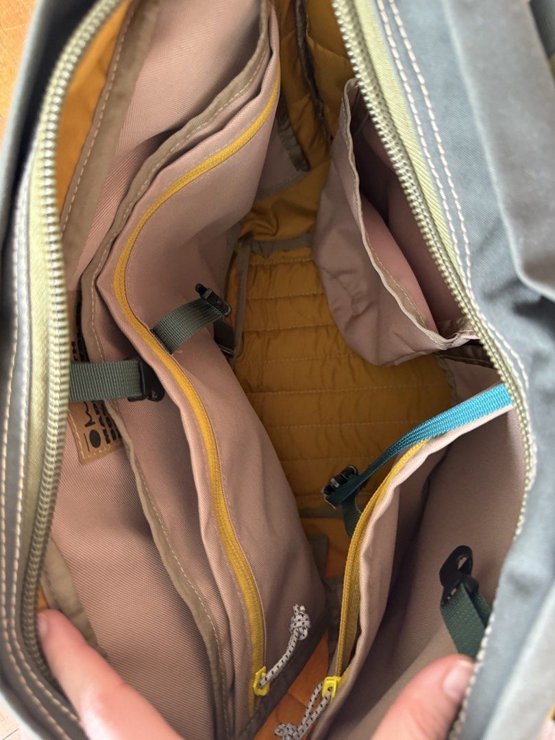 Carry Om Garuda 13” (Category: Tote Bags) located in Binan City. Submitted by julia1923 (Listing ID 1467636354, Image 3). Description: - RFS not a fan of the brand anymore - Fits a Macbook air - Color Block Design: Stylish mustard yellow, green, and dark grey with unique wavy blue stitching - Spacious & Organized: Large main compartment with a secure zipper closure and multiple interior pockets/pouches - Durable Material: High-quality quilted nyl