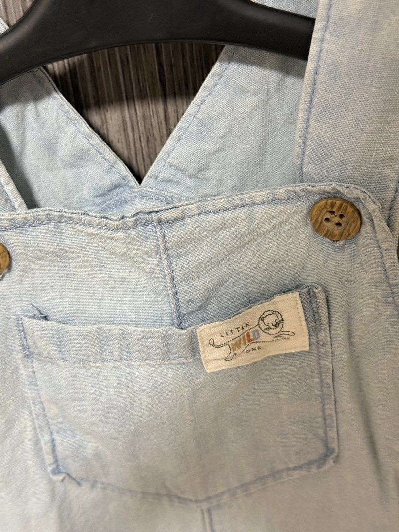 Carters baby denim rompers light wash (Category: Babies & Kids Fashion) located in Quezon City. Submitted by ketch10 (Listing ID 1467652107, Image 2). Description: - Adorable light wash denim baby overalls - Features a cute 'Little Wild One' lion patch on the chest pocket - Wooden-style buttons on the straps and sides - Convenient snap buttons along the crotch for easy diaper changes - Short legs with trendy cuffed hems - Soft and comfortable fab