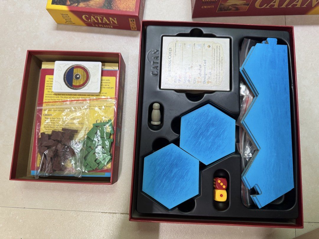 Catan Base Game with 5-6 Player Extension (Category: Board Games & Puzzles) located in Manila. Submitted by khimellorin (Listing ID 1467832309, Image 2). Description: - Catan base game bundled with the 5-6 player extension box - Includes all hex tiles, wooden player pieces, cards, dice, and manuals - Complete components packed securely in original storage inserts - Perfect strategy game for larger group game nights - 100% accounted for and ready 