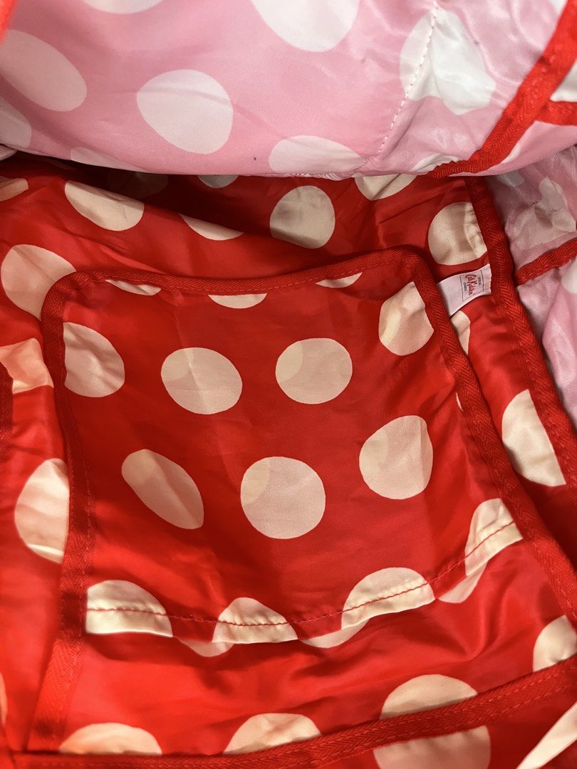 Cath Kidston Red Polka Dot Backpack (Category: Backpacks) located in Caloocan City. Submitted by snapshop_ph (Listing ID 1467644915, Image 3). Description: - Brand/Model: Authentic Cath Kidston Backpack - Design: Classic red and white polka dot pattern with matching interior lining - Features: Front zip pocket, fabric straps, and interior slip pocket - Condition: Clean interior; minor yellowing on exterior fabric spots near zippers and upper edge