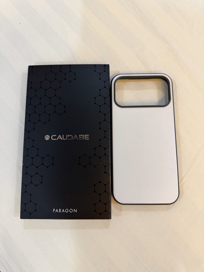 Caudabe Paragon Moonstone (Open) iPhone 17 Pro Max (Category: Cases & Sleeves) located in Pasig City. Submitted by dey2x (Listing ID 1467739770, Image 1). Description: Caudabe Paragon Moonstone (Open) iPhone 17 Pro Max Slightly used condition Slight scratches on the back MagSafe compatible Pasig / Quezon City area.