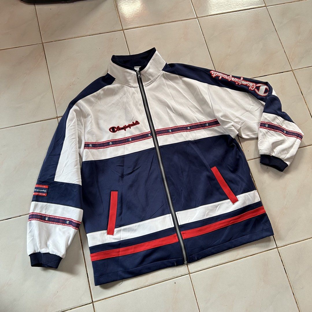 Champion vintage colourblock track jacket 🥵 (Category: Coats, Jackets and Outerwear) located in Jinoba-an. Submitted by eegiboy (Listing ID 1467649812, Image 3). Description: - Brand/Style: Vintage Champion colourblock track jacket - Colourway: White, navy blue, and red - Size: Medium - Design: Full zip front, stand collar, front slash pockets, elastic cuffs and hem - Details: Striking embroidered Champion graphics down the left sleeve, chest, b