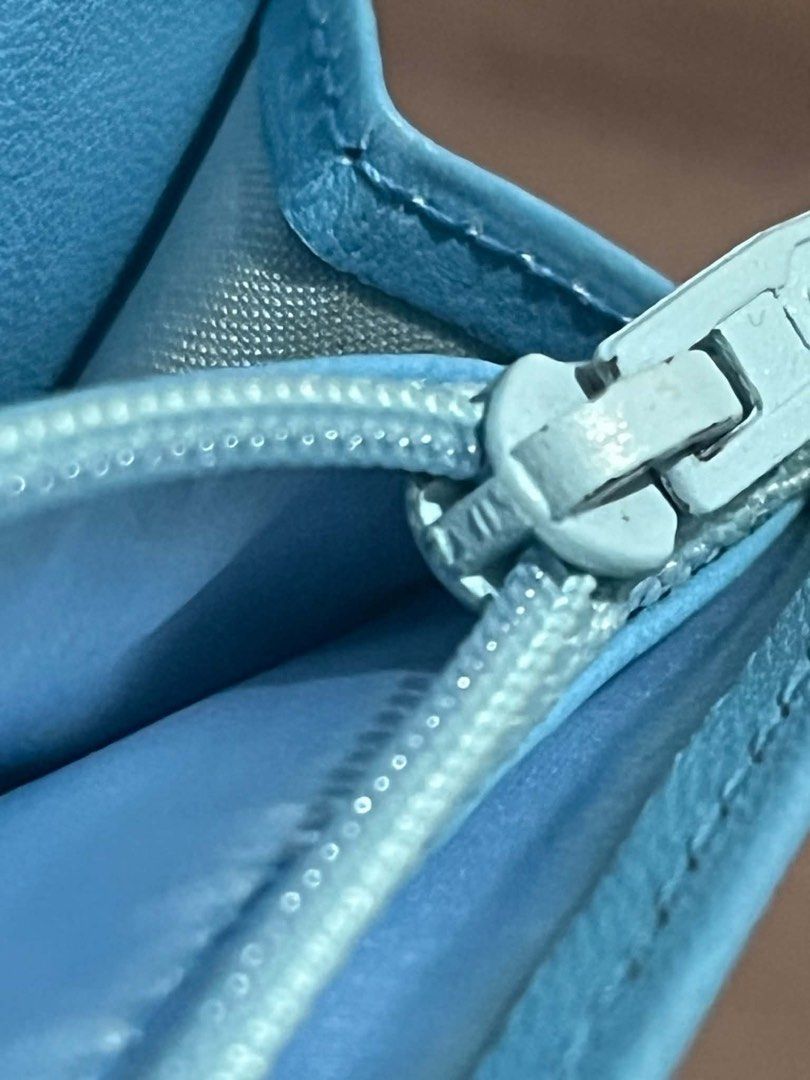 Chanel Travel line Long Wallet (Category: Luxury Bags & Wallets) located in Cavite. Submitted by playerscollection (Listing ID 1467645875, Image 3). Description: Chanel New Travel Line Long Bifold Wallet in a light blue nylon or jacquard fabric featuring the classic checkerboard grid and CC logo. Key Details: • Brand: Chanel • Line: New Travel Line • Material: Nylon / Jacquard fabric • Color: Light Blue • Style: Long bifold wallet • Approximate D