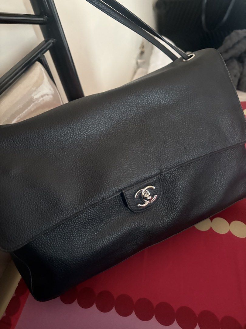 Chanel Maxi flap Black (Category: Luxury Bags & Wallets) located in Manila. Submitted by dolls20 (Listing ID 1467605709, Image 2). Description: - Authentic black grained leather shoulder bag with a soft pebble texture - Sleek silver hardware featuring the signature CC twist-lock front flap closure - Slim adjustable leather straps accented with branded metallic buckle details - Structured rectangular body that maintains its shape - Clean and spaci