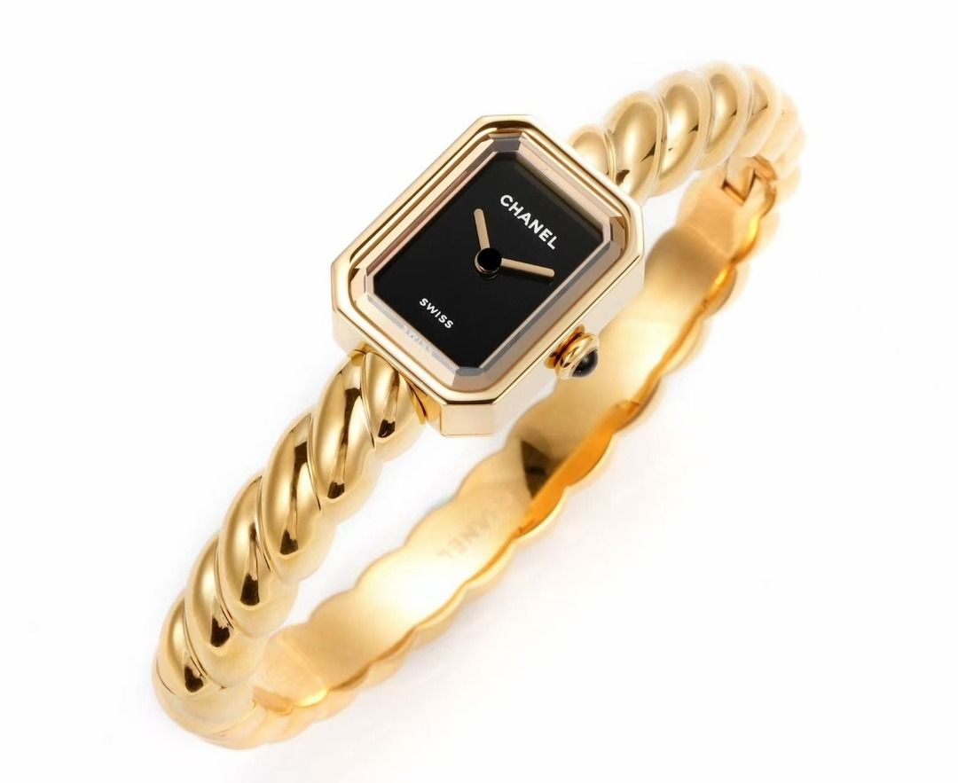 Chanel Premiere Twist Gold Bangle Watch (Category: Women's Watches) located in Paranaque City. Submitted by emoemobern98221 (Listing ID 1467663586, Image 2). Description: - Brand: Chanel Premiere - Design: Gold-tone twisted bangle strap with rectangular black dial - Details: Minimalist hands, crown with dark stone cabochon - Origin: Swiss Made - Style: Classic timepiece that wears like a luxury bracelet - Condition: Clean, polished metal finish a