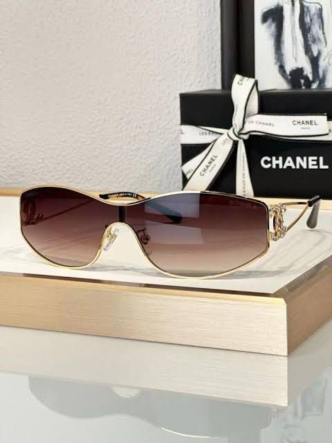Chanel Rhinestone CC Shield Sunglasses with Box (Category: Sunglasses & Eyewear) located in Paranaque City. Submitted by kyriaki_thrift_shop (Listing ID 1467714980, Image 1). Description: Style: Shield sunglasses in gold metal with brown gradient lenses - Details: Crystal rhinestone encrusted interlocking CC logos on both temples - Condition: Pristine lenses, minor reflections in photos only - Inclusions: Black quilted hard case, original box, an