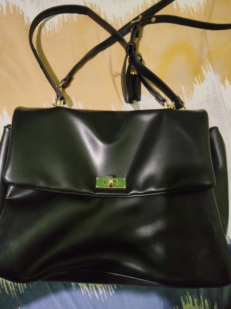 Charles & Keith black Kerry Bag (Category: Shoulder Bags) located in San Pedro. Submitted by eye_spy (Listing ID 1467838975, Image 1). Description: Black shoulder bag from Charles and Keith. Gold tone hardware on the twist lock closure and zipper pull. Adjustable strap attached. Structured silhouette with folded top flap. Interior lined in dark fabric with a branded patch sewn inside. Clean surfaces all around. used twice only. no issues. looks n