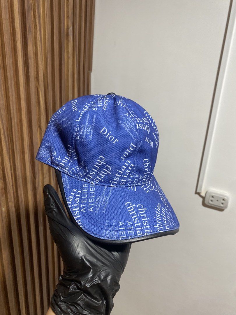 Christian Dior Blue Atelier Print Baseball Cap (Category: Caps & Hats) located in Caloocan City. Submitted by heatedcaps4425 (Listing ID 1467804249, Image 2). Description: - Brand: Christian Dior Atelier - Color: Royal blue with white text print and black leather brim edge - Material: 100% polyester (Made in Italy, Designed in LA) - Interior: Brown lining with adjustable back strap - Condition: Excellent / Pre-loved (ready to wear).