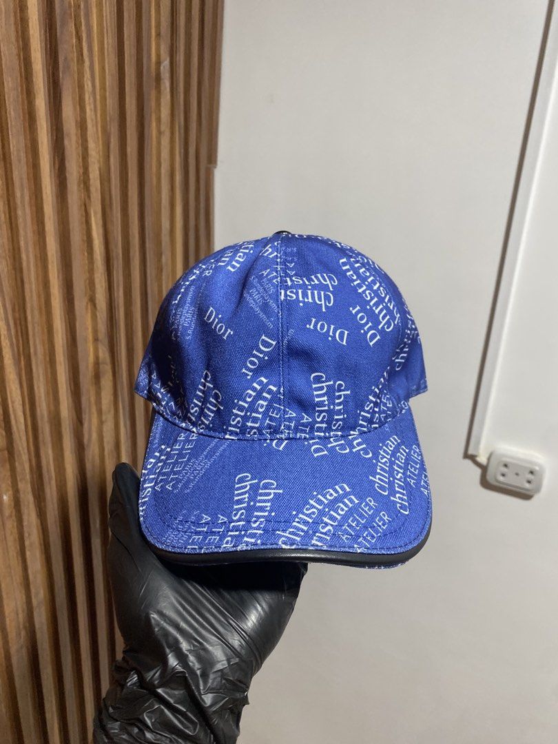 Christian Dior Blue Atelier Print Baseball Cap (Category: Caps & Hats) located in Caloocan City. Submitted by heatedcaps4425 (Listing ID 1467804249, Image 1). Description: - Brand: Christian Dior Atelier - Color: Royal blue with white text print and black leather brim edge - Material: 100% polyester (Made in Italy, Designed in LA) - Interior: Brown lining with adjustable back strap - Condition: Excellent / Pre-loved (ready to wear).
