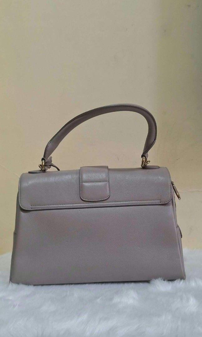 Christian Dior Top Handle Push Lock Bag (Category: Luxury Bags & Wallets) located in Quezon City. Submitted by rc.cici (Listing ID 1467778636, Image 2). Description: Christian Dior Top Handle Push Lock Bag Condition: Good guarantee authentic with card and provided dustbag.