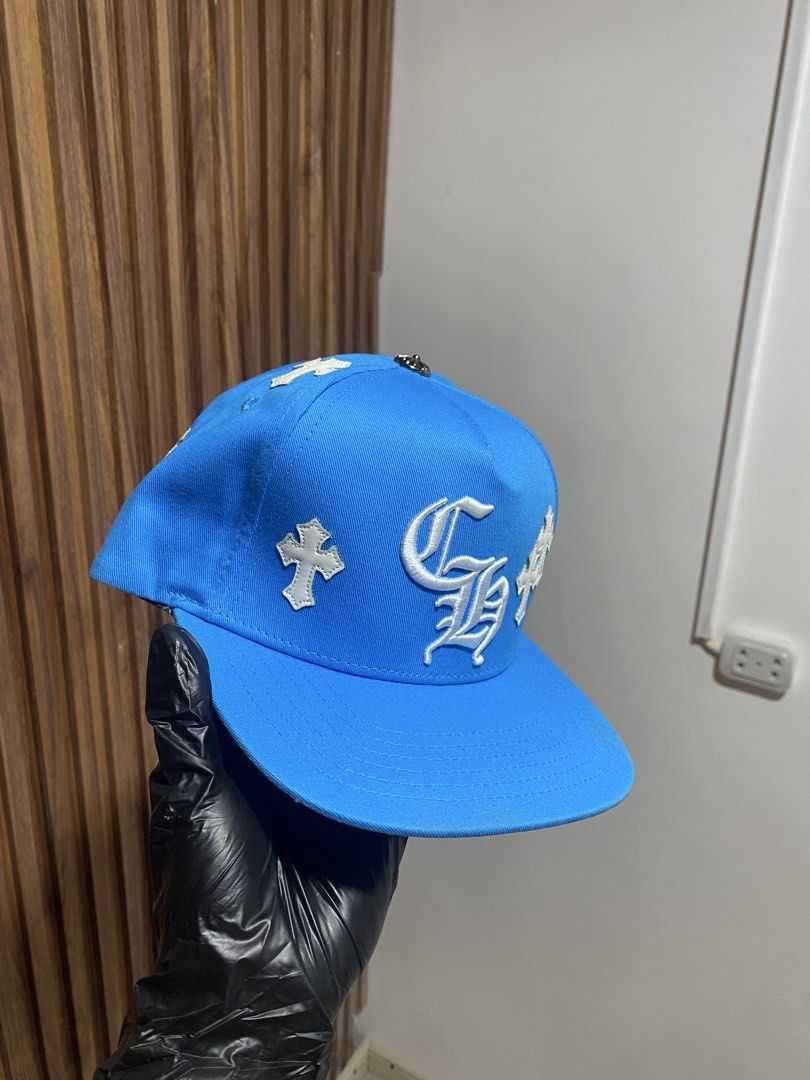 Chrome Hearts Blue Cross Patch Snapback Hat (Category: Caps & Hats) located in Caloocan City. Submitted by heatedcaps4425 (Listing ID 1467801622, Image 2). Description: - Brand: Chrome Hearts - Style: Snapback Cap - Color: Bright blue with white accents - Details: White leather cross patches all over, large Gothic CH embroidered front logo, arched "Chrome Hearts" back lettering - Hardware: Silver metallic top button - Closure: Adjustable snap str