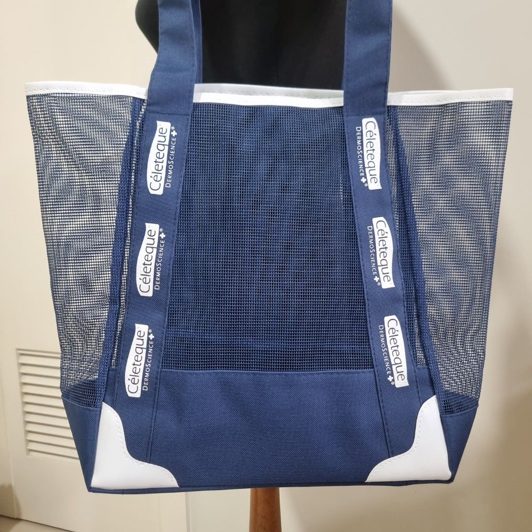 Céleteque Blue Mesh Tote Bag (Category: Tote Bags) located in Pasig City. Submitted by lesmitch (Listing ID 1467645802, Image 2). Description: - Color: Navy blue and white - Material: Lightweight mesh body with solid blue trim - Design: Open top with sturdy handles, white bottom corner reinforcements, and printed strap branding ~ Check all photos for the item's actual condition and measurements ~ Payment is via gcash, pay maya or bdo ~ Shipping i