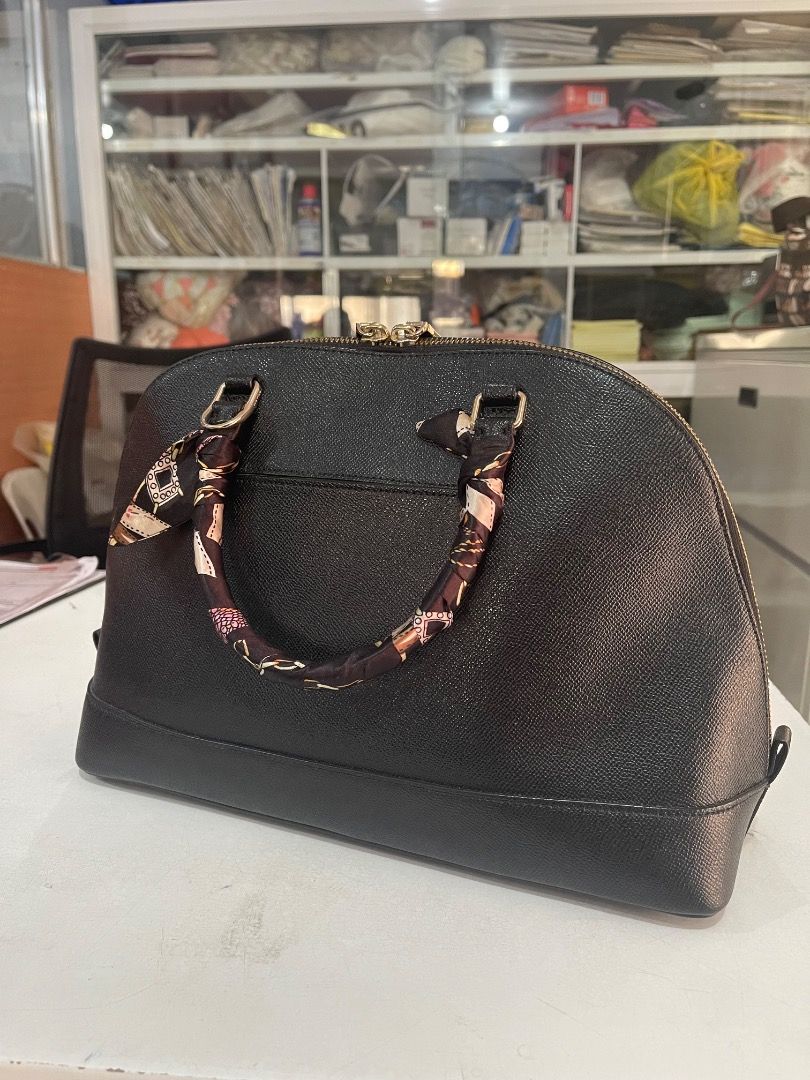 Coach Black Dome Satchel Handbag (Category: Luxury Bags & Wallets) located in Subic. Submitted by anything_lovely_under_the_sun (Listing ID 1467837934, Image 2). Description: Coach dome satchel in black textured leather. Gold-tone hardware details, dual zippered closure, protective metal feet on the bottom. Rolled top handles wrapped with a printed twill scarf ribbon. Includes a hanging Coach leather luggage tag. Interior has plenty of room for d