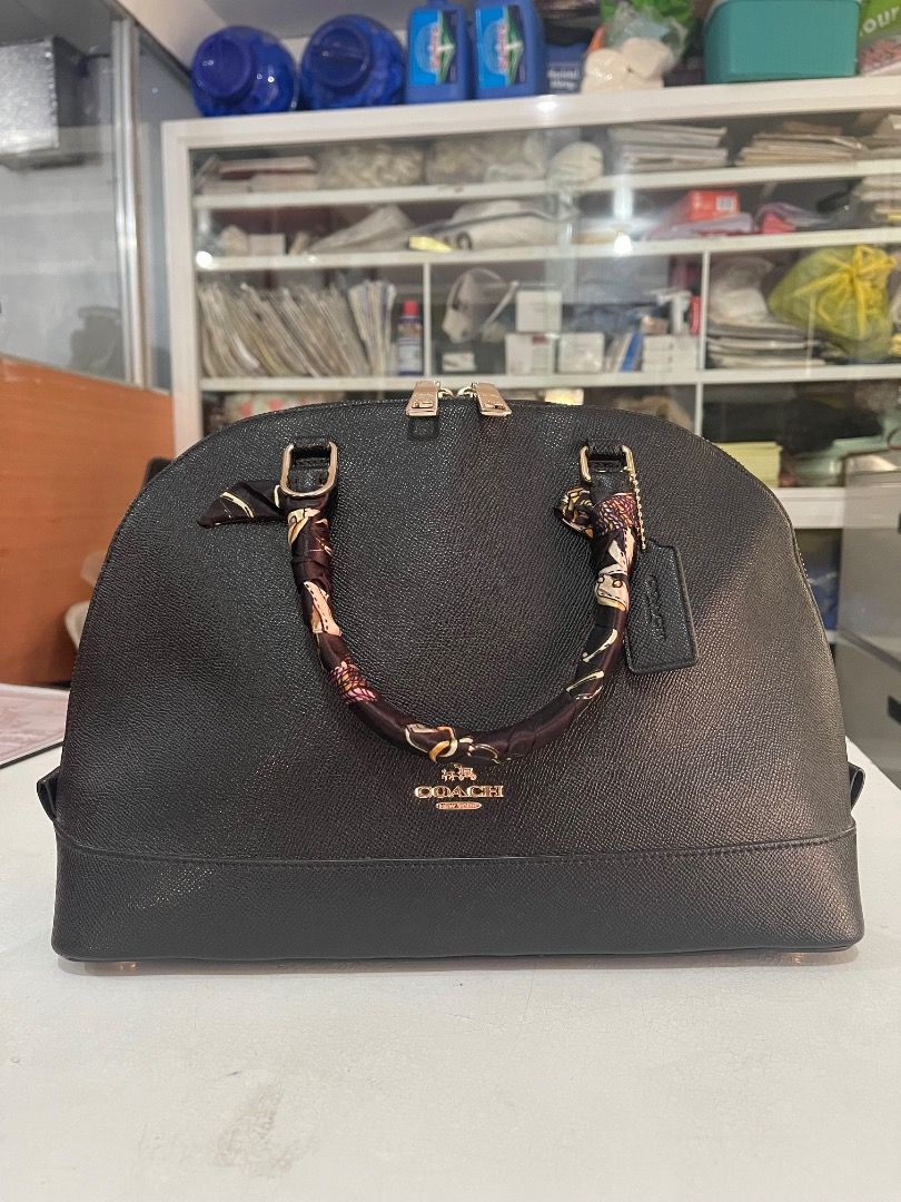 Coach Black Dome Satchel Handbag (Category: Luxury Bags & Wallets) located in Subic. Submitted by anything_lovely_under_the_sun (Listing ID 1467837934, Image 1). Description: Coach dome satchel in black textured leather. Gold-tone hardware details, dual zippered closure, protective metal feet on the bottom. Rolled top handles wrapped with a printed twill scarf ribbon. Includes a hanging Coach leather luggage tag. Interior has plenty of room for d