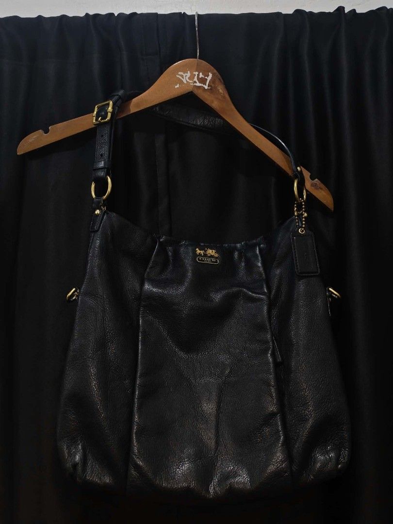 Coach Black Leather Shoulder Bag (Category: Luxury Bags & Wallets) located in Baguio. Submitted by solo_ukay (Listing ID 1467777904, Image 1). Description: - Style: Slouchy hobo shoulder bag - Material: Soft grained black leather - Hardware: Gold-toned brass with iconic Coach plaque and matching hangtag - Interior: Vibrant purple satin lining with a secure zippered pocket - Strap: Adjustable with a gold buckle for a custom fit - Condition: Excell