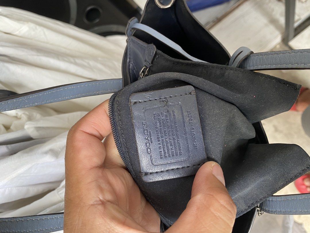 Coach Blue Leather Tote Bag (Category: Tote Bags) located in Alburquerque. Submitted by zanegavynn43872 (Listing ID 1467694300, Image 2). Description: - Brand: Coach - Style: Medium leather tote bag / everyday carryall - Color: Faded blue with dark fabric interior lining - Features: Dual shoulder straps, matching hangtag, interior zip pocket, and creed patch with serial number (A2079-78217) - Condition: Exterior shows scuffs, marks, and general s