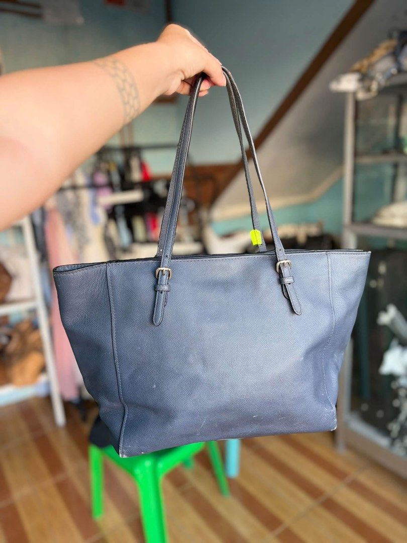 Coach Dark Grey Tote Bag with Cherry Charm (Category: Tote Bags) located in Manila. Submitted by meegy (Listing ID 1467622217, Image 2). Description: - Authentic Coach leather tote in a versatile dark grey shade - Secure zip-top closure with a dark fabric-lined interior and creed patch - Dual shoulder straps with adjustable buckle details for a custom fit - Includes a charming gold chain keychain featuring red crystal cherry charms and a 'C' logo