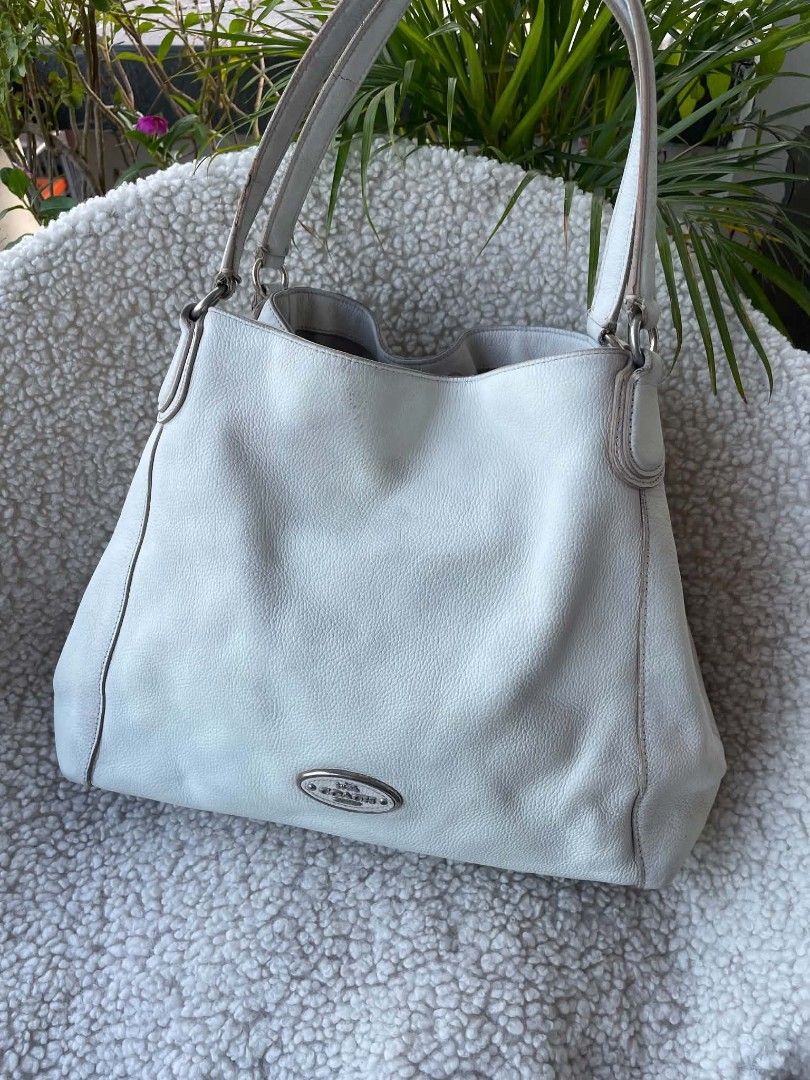 Coach Edie 31 White Pebbled Leather Shoulder Bag (Category: Shoulder Bags) located in Bulacan. Submitted by bagzandboujee_ (Listing ID 1467794739, Image 1). Description: Coach Edie 31 White Pebbled Leather Shoulder Bag ʀᴀɴᴋ ʙ ᴘʜᴘ ♥︎ 800 Ink stain/penmark at the back part leather signs of usage on rubber lining signs of use on corners leather patina leather discoloration ♥︎ ᴀʟʟ ꜱᴀʟᴇꜱ ᴀʀᴇ ꜰɪɴᴀʟ ᴋɪɴᴅʟʏ ʀᴇᴠɪᴇᴡ ᴀʟʟ ᴘʜᴏᴛᴏꜱ & ᴅᴇꜱᴄʀɪᴘᴛɪᴏɴ ʙᴇꜰᴏʀᴇ ᴘᴜʀᴄʜᴀꜱɪ