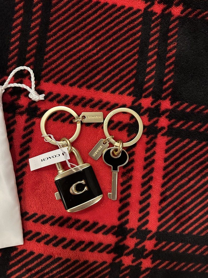 Coach Lock and Key Charm Keychain Set (Category: Luxury Accessories) located in Caloocan City. Submitted by kristel3094 (Listing ID 1467756503, Image 3). Description: - Authentic Coach keychain set - Chic black color with elegant gold hardware - Features a stylish lock and key design - Includes 2 separate ring clips with Coach tag accents - Comes with a white Coach dust bag - Versatile: great for organizing keys or styling your favorite bag.