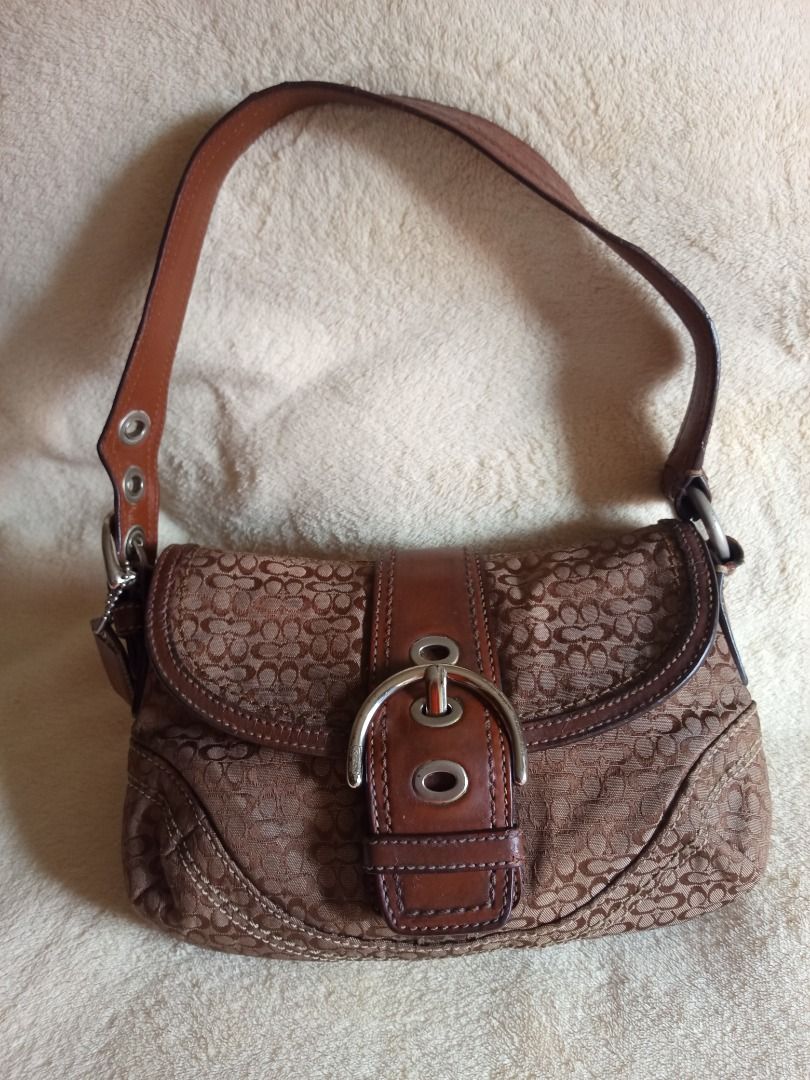 Coach Mini Soho Signature Flap (Category: Luxury Bags & Wallets) located in Cabuyao City. Submitted by dennie_05 (Listing ID 1467616824, Image 2). Description: FS‼️ Personal preloved Coach Mini Soho Signature Flap. Rank B. - No issues on canvas (no rubs/stains) - Clean inside - Has issues on leather strap (has cracks, repainted some parts) - 8/10 hardware condition Willing to send videos. Dm for more infos! Loc. Cabuyao, Laguna MOP. Gcash/Mariban