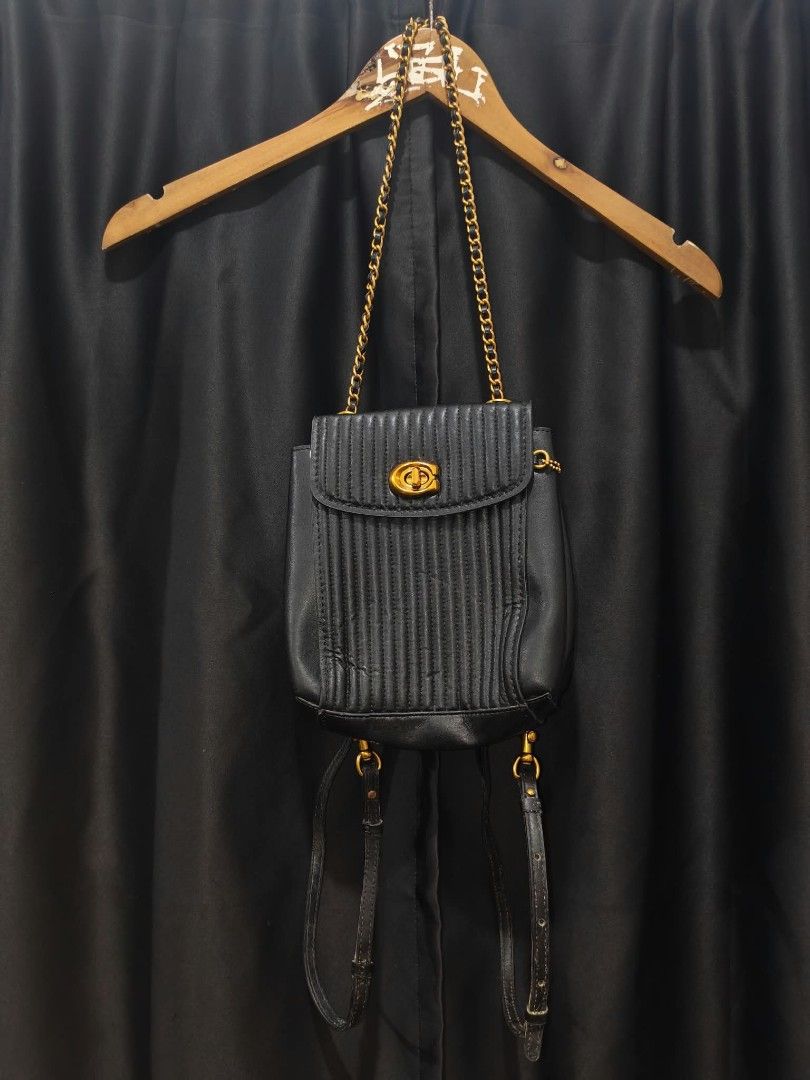 Coach Quilted Leather Backpack Black Gold Hardware (Category: Backpacks) located in Baguio. Submitted by solo_ukay (Listing ID 1467777571, Image 1). Description: - Authentic Coach black quilted leather backpack - Elegant gold-tone hardware with classic turnlock closure - Versatile wear with chain shoulder straps and adjustable leather back straps - Convenient exterior zipper pocket on the back - Beautiful deep maroon interior lining complete with